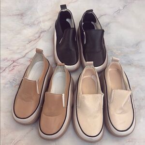 3 pairs of slip on sneakers in black tan and cream. Size 7.